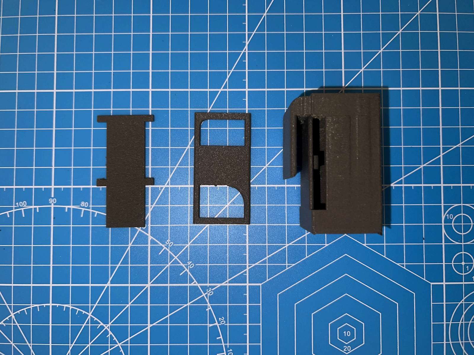 3D-printed enclosure parts on a cutting mat